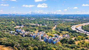 A bird's eye view of a city surrounded by greenery.